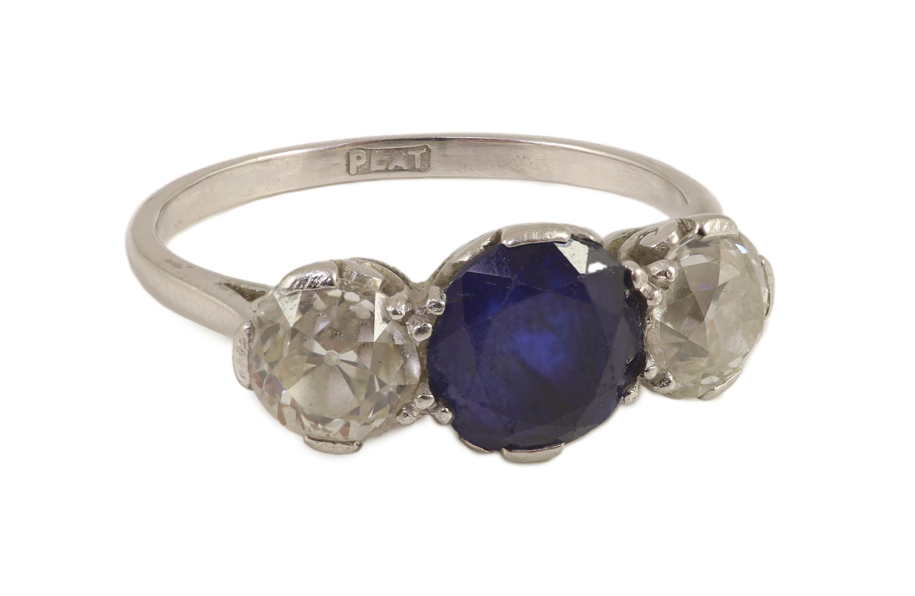 A platinum two stone diamond and single stone sapphire ring